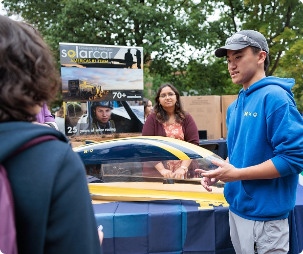 Students talking about a solar car showcase