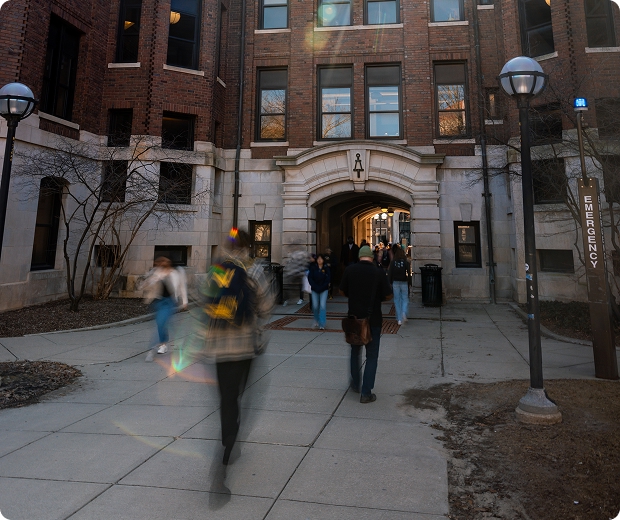 Students walk through the West Hall archway