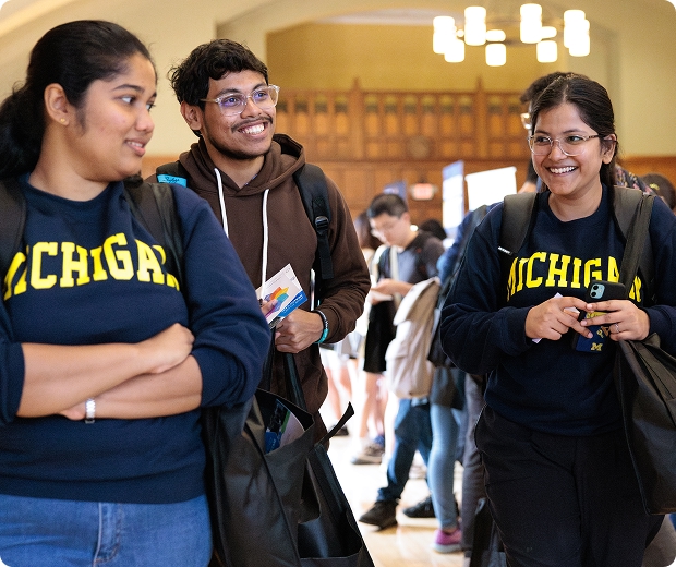 Students smiling and talking in the hall during FestiFall