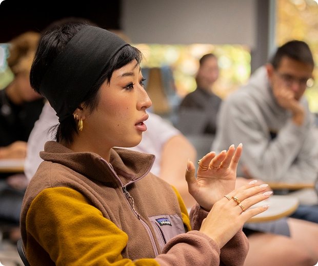 A student in class responding to a faculty member